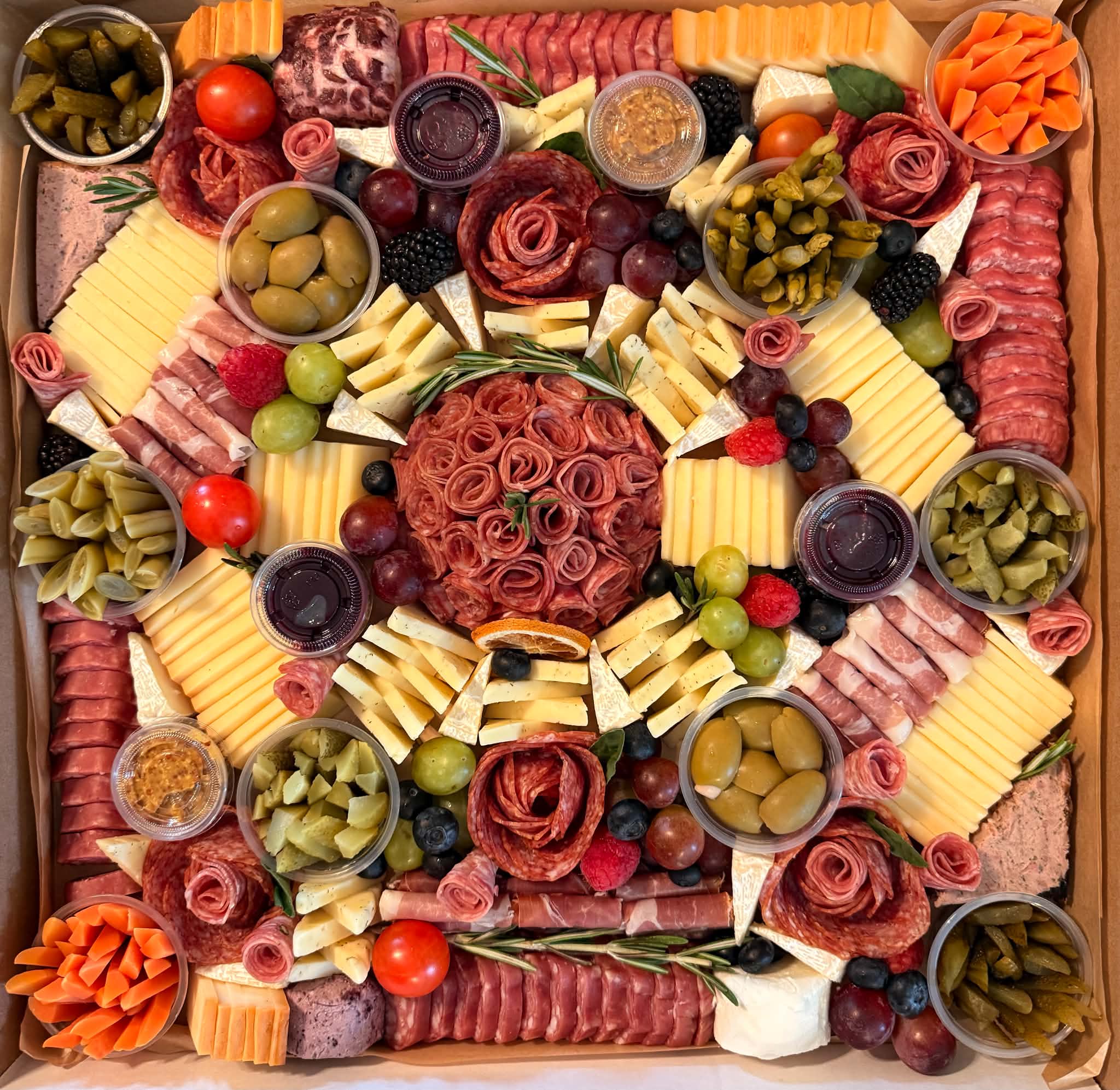 A beautifully arranged Rustic Box board with artisan cheeses, cured meats, fresh fruit and accompaniments