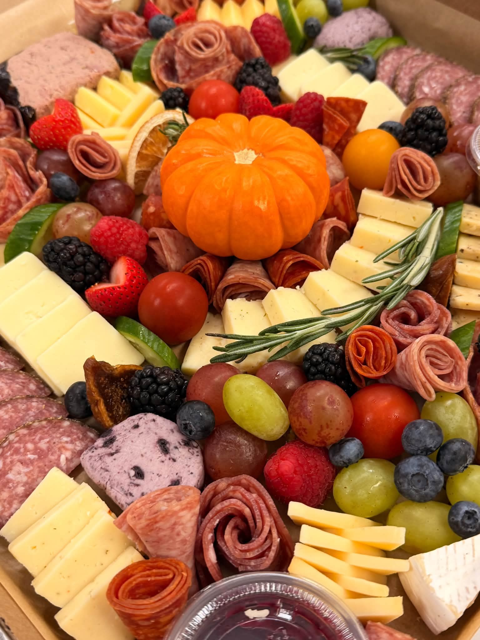 Autumn charcuterie details with a seasonal mini pumpkin